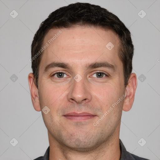 Joyful white adult male with short  brown hair and grey eyes