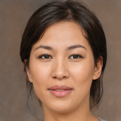 Joyful asian young-adult female with medium  brown hair and brown eyes