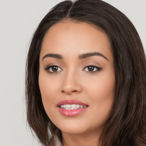 Joyful white young-adult female with long  brown hair and brown eyes