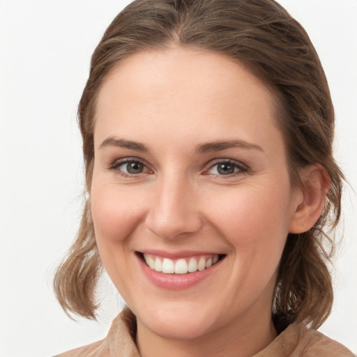 Joyful white young-adult female with medium  brown hair and blue eyes