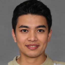 Joyful latino young-adult male with short  brown hair and brown eyes