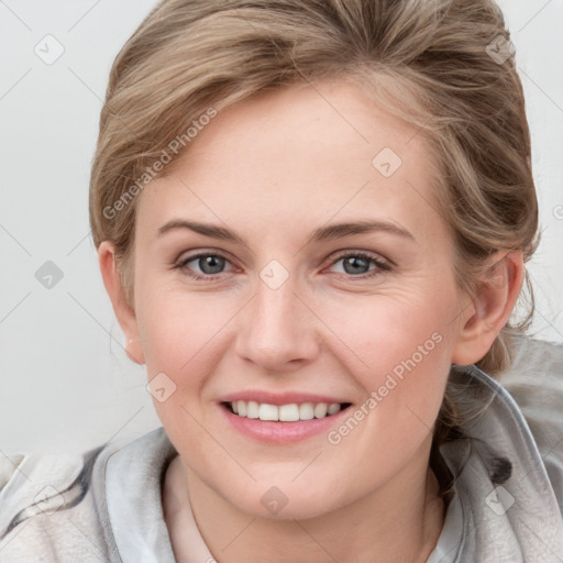 Joyful white young-adult female with medium  brown hair and blue eyes