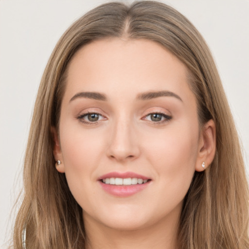 Joyful white young-adult female with long  brown hair and grey eyes