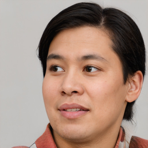 Joyful asian young-adult male with medium  brown hair and brown eyes