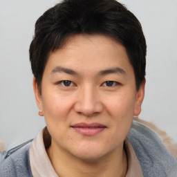 Joyful asian young-adult male with short  brown hair and brown eyes