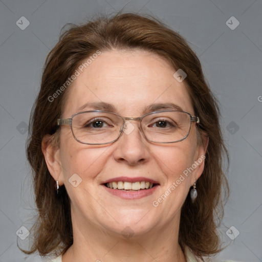 Joyful white adult female with medium  brown hair and blue eyes