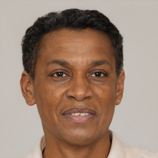 Joyful black adult male with short  brown hair and brown eyes