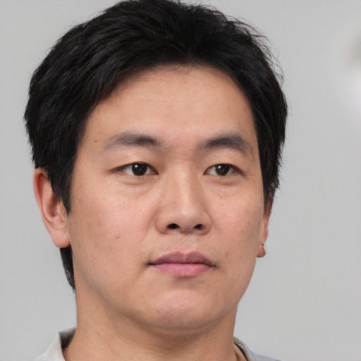 Neutral asian young-adult male with short  brown hair and brown eyes