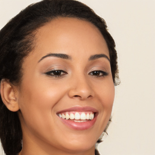 Joyful latino young-adult female with long  brown hair and brown eyes