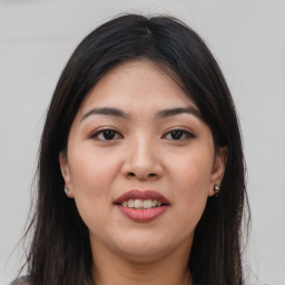 Joyful latino young-adult female with long  brown hair and brown eyes