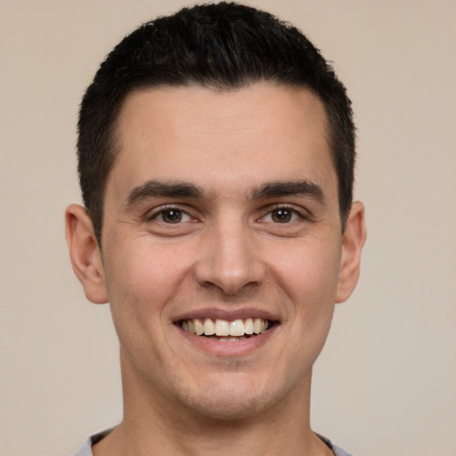 Joyful white young-adult male with short  black hair and brown eyes