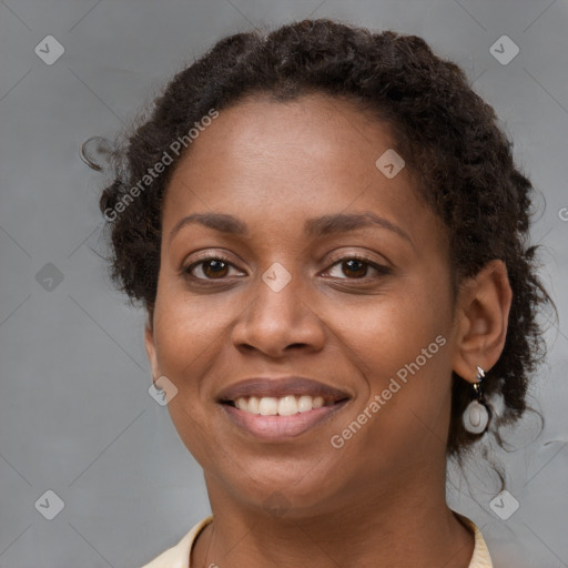 Joyful black young-adult female with short  brown hair and brown eyes