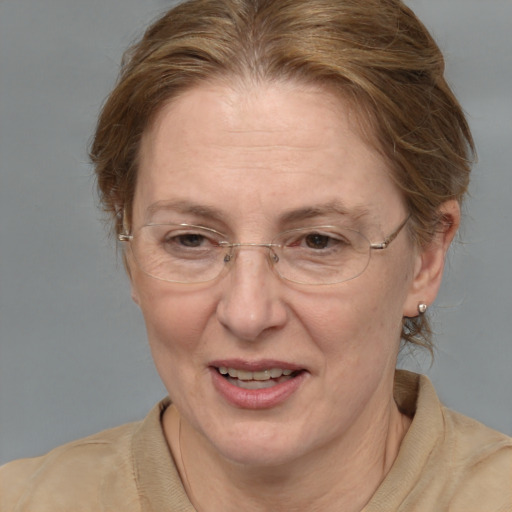 Joyful white middle-aged female with medium  brown hair and brown eyes