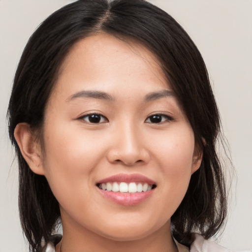 Joyful white young-adult female with medium  brown hair and brown eyes