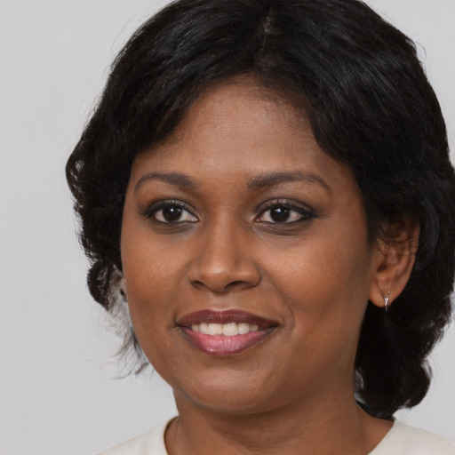 Joyful black adult female with medium  black hair and brown eyes