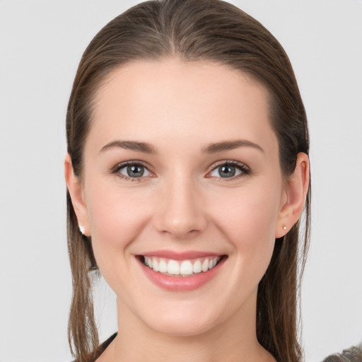 Joyful white young-adult female with long  brown hair and grey eyes