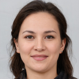 Joyful white young-adult female with medium  brown hair and brown eyes