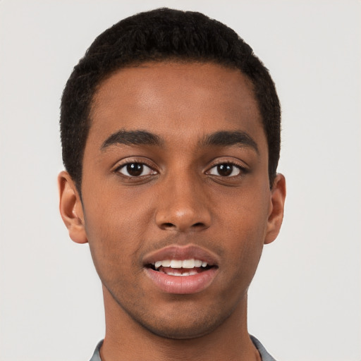 Joyful black young-adult male with short  brown hair and brown eyes