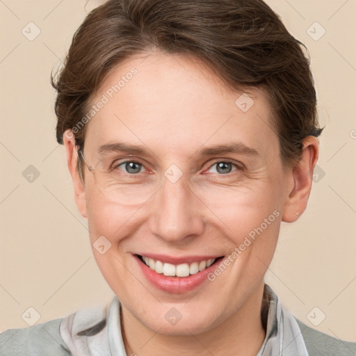 Joyful white adult female with short  brown hair and grey eyes