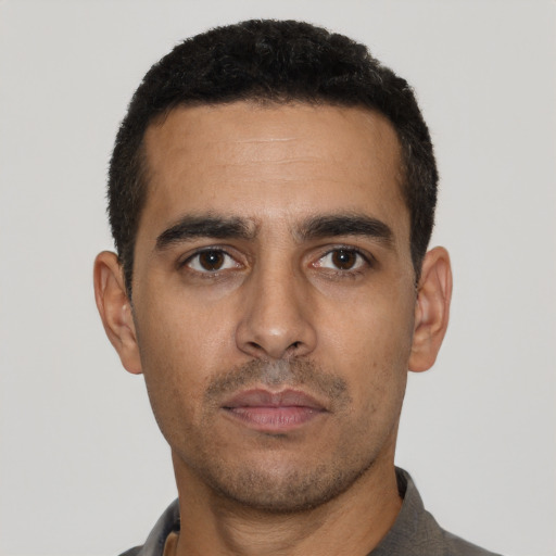 Neutral latino young-adult male with short  black hair and brown eyes
