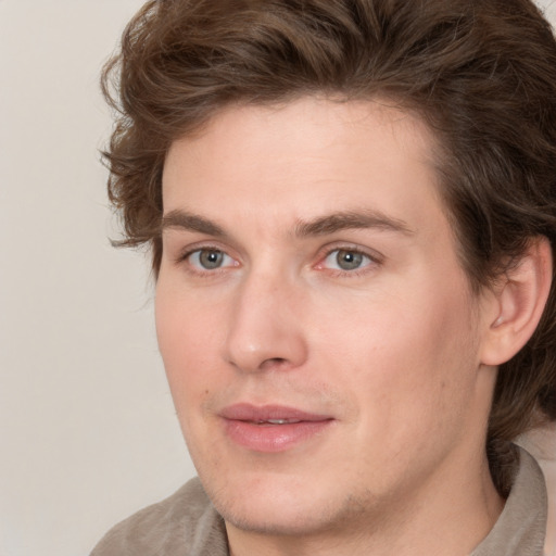 Joyful white young-adult male with medium  brown hair and brown eyes