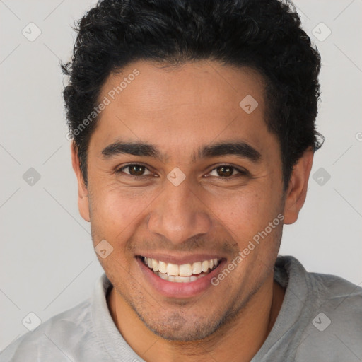 Joyful latino young-adult male with short  brown hair and brown eyes
