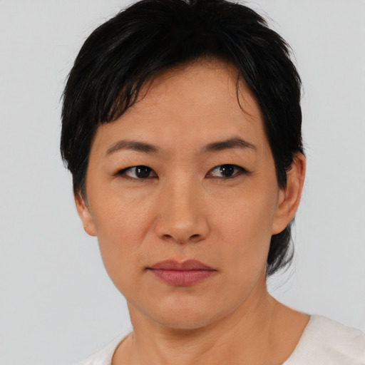 Joyful asian adult female with short  black hair and brown eyes