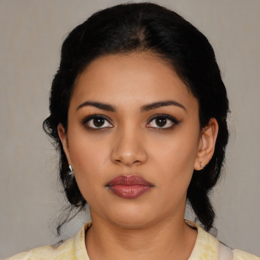 Joyful latino young-adult female with medium  black hair and brown eyes