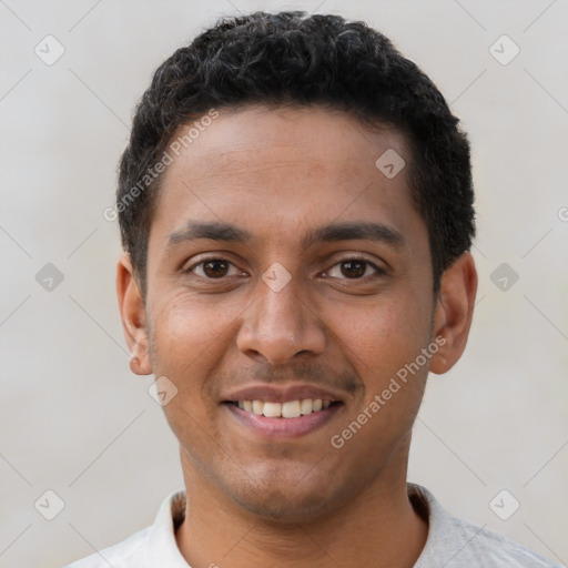 Joyful latino young-adult male with short  black hair and brown eyes