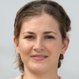 Joyful white young-adult female with medium  brown hair and brown eyes