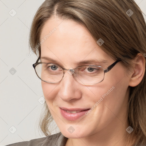 Joyful white adult female with medium  brown hair and grey eyes