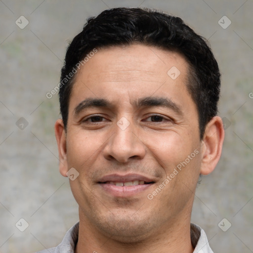 Joyful white adult male with short  black hair and brown eyes