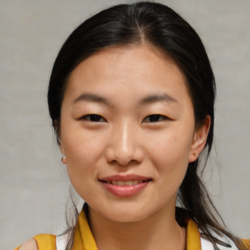 Joyful asian young-adult female with medium  brown hair and brown eyes