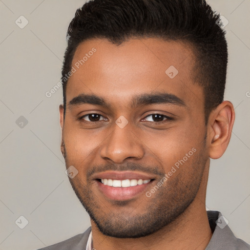 Joyful black young-adult male with short  brown hair and brown eyes