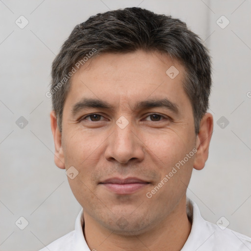 Joyful white adult male with short  black hair and brown eyes