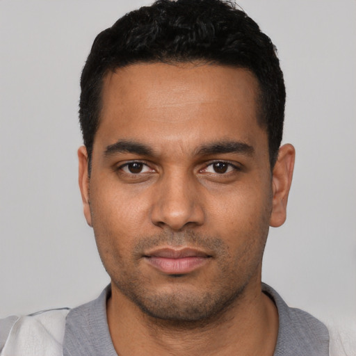 Neutral latino young-adult male with short  black hair and brown eyes