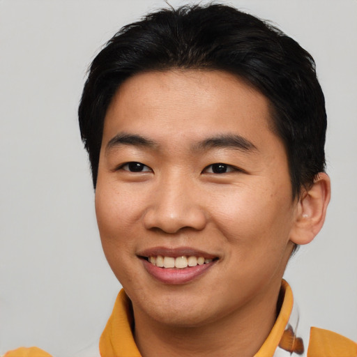 Joyful asian young-adult male with short  brown hair and brown eyes