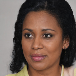 Joyful black young-adult female with medium  brown hair and brown eyes