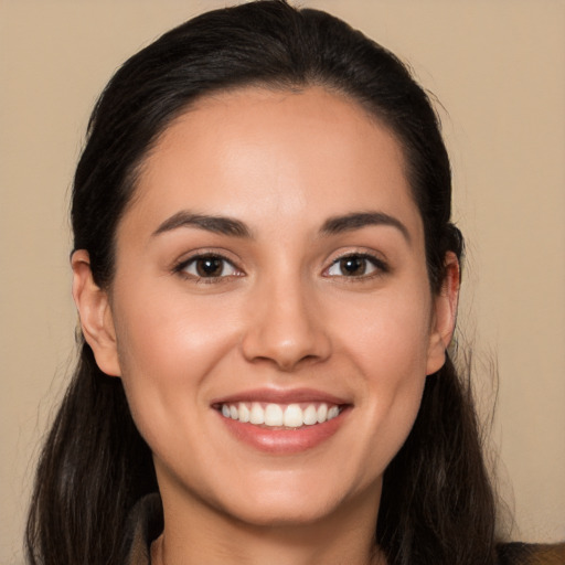 Joyful white young-adult female with long  brown hair and brown eyes