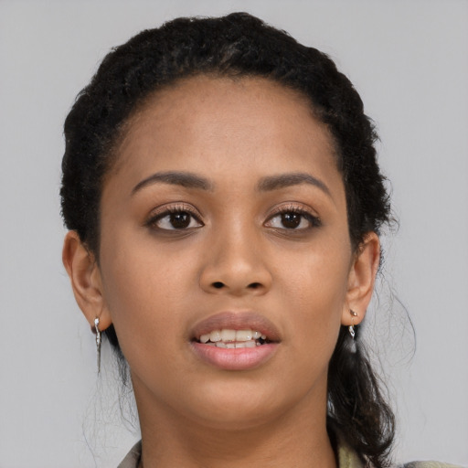 Joyful latino young-adult female with long  black hair and brown eyes