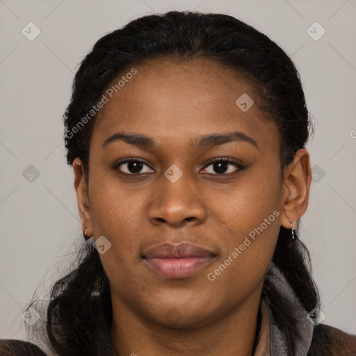 Joyful black young-adult female with long  black hair and brown eyes