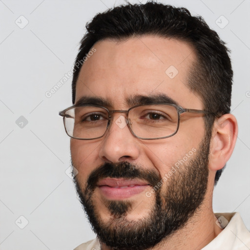 Joyful white adult male with short  black hair and brown eyes