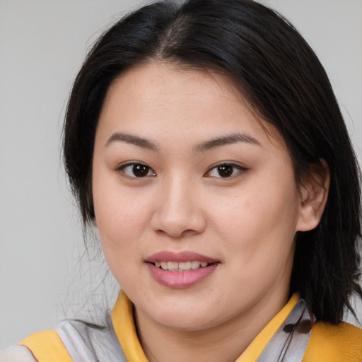 Joyful asian young-adult female with medium  brown hair and brown eyes