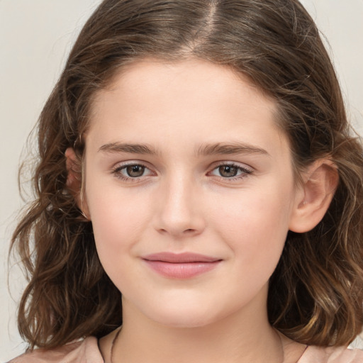 Joyful white child female with medium  brown hair and brown eyes