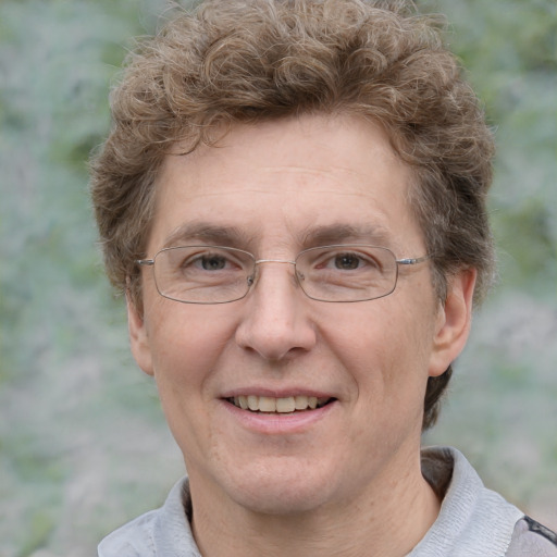 Joyful white adult male with short  brown hair and grey eyes