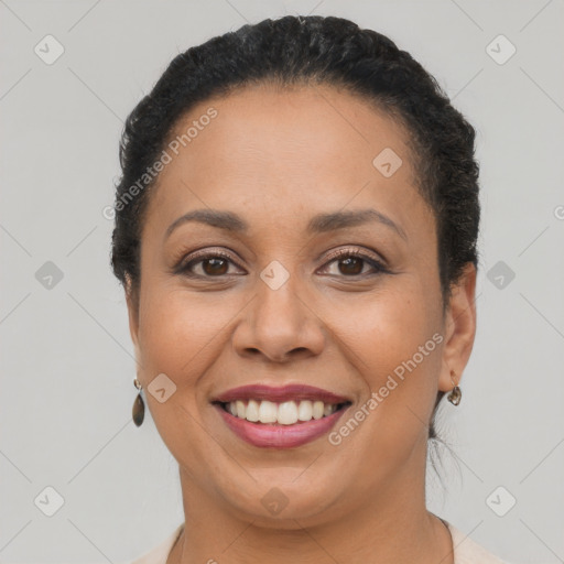 Joyful latino adult female with short  brown hair and brown eyes