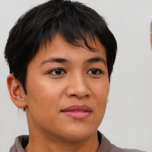 Joyful asian young-adult female with short  brown hair and brown eyes