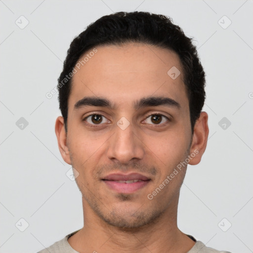Joyful latino young-adult male with short  black hair and brown eyes
