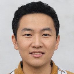 Joyful asian young-adult male with short  brown hair and brown eyes