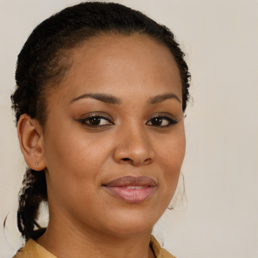 Joyful black young-adult female with long  brown hair and brown eyes